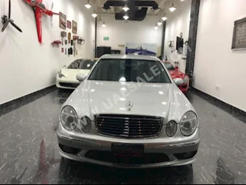Cars For Sale Mercedes-Benz  E-Class  55 AMG  85,000  Silver  Sedan  Automatic  RWD  Leather  2006  4  Yes  Gasoline